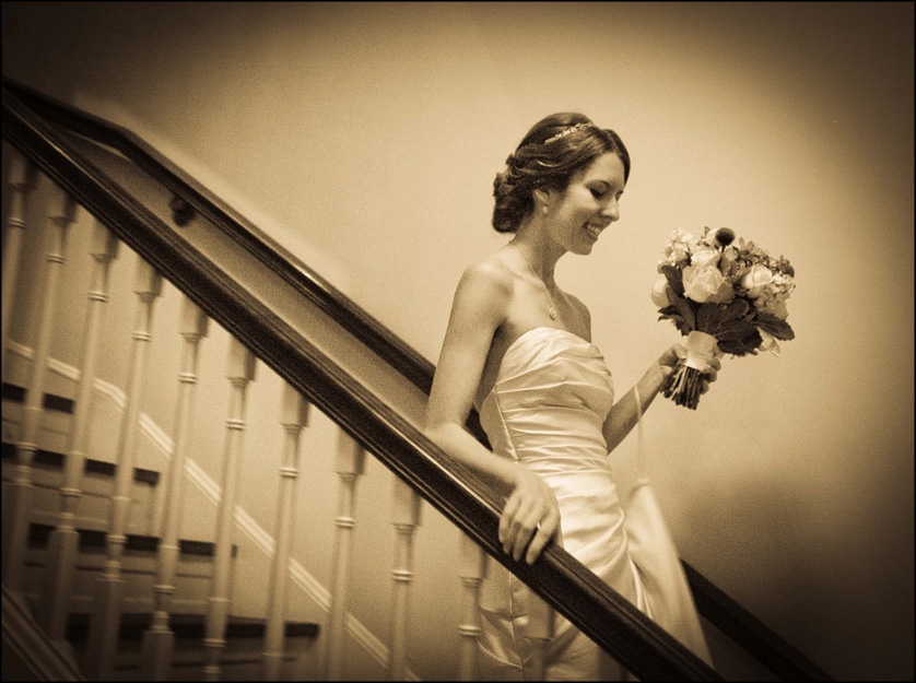 Beautiful bride walks down stairs at the Presbyterian Church of Chestnut Hill