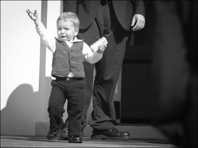 happy baby walks outside after the wedding ceremony