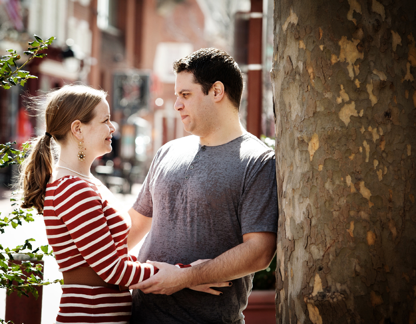 Couple looks at each other in busy South Philly square near South Street