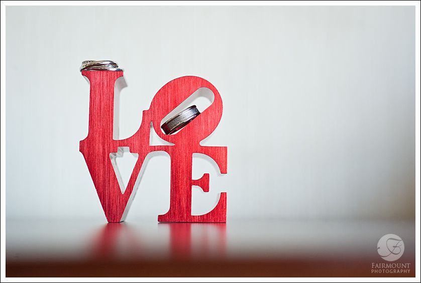 Miniature LOVE statue with wedding rings