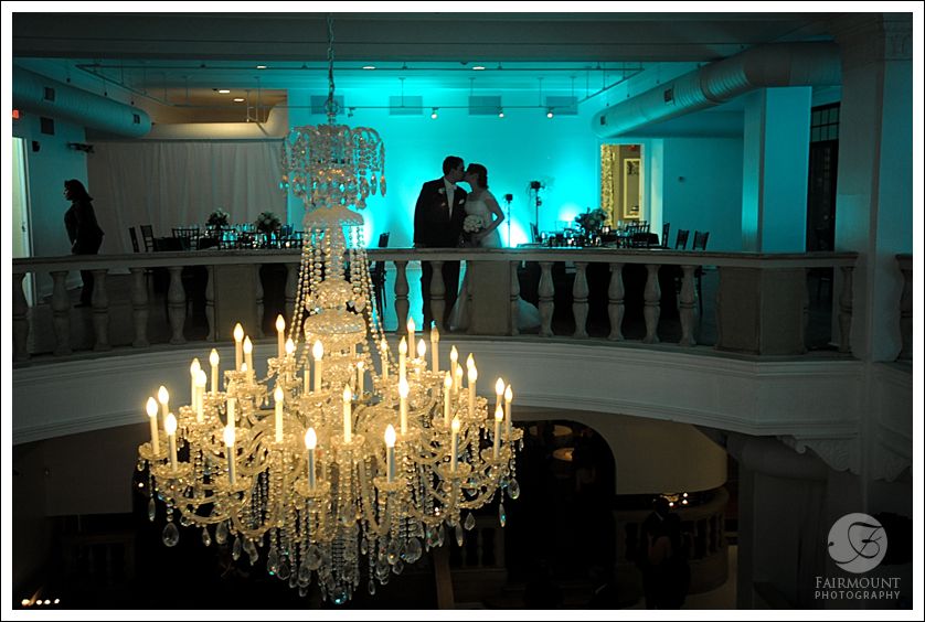 Chandelier with silhouette of bride and groom in the background