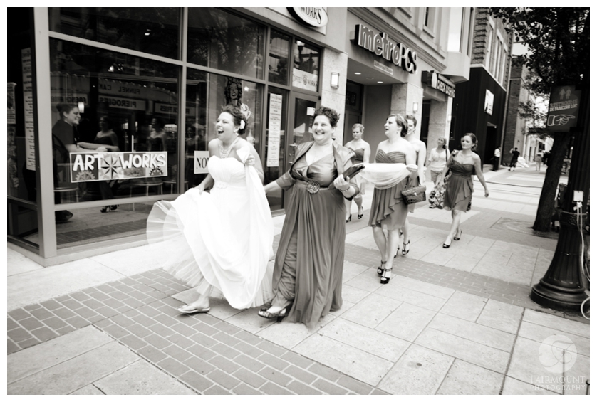 bride & bridesmaids walk through city to wedding