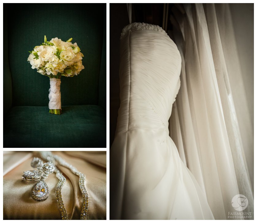 White bridal bouquet on green chair, platinum purse with diamond wedding jewelry and wedding gown in window
