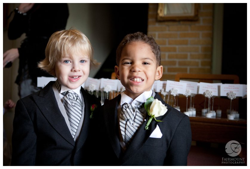 Two ringbearers with gray-striped cravats smiling before ceremony