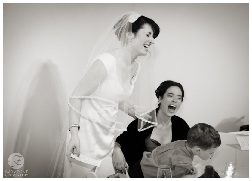 bride laughs with sister during the Tish, a Jewish pre-ceremony ritual