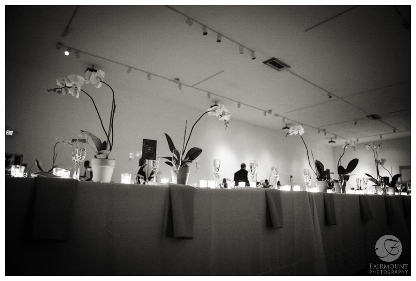 long tables at reception with orchid centerpieces