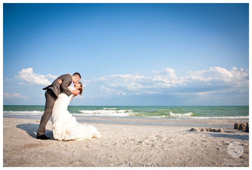 groom dips bride for a portrait on the beach at a destination wedding in Sanibel Island, FL