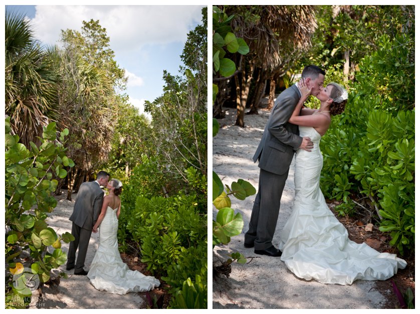 bride and groom kiss on sandy path through green vegetation at florida wedding