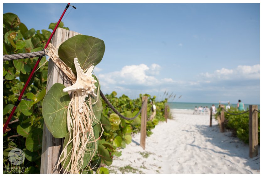 sea grape leaves and starfish decorate path to beach wedding in South Florida