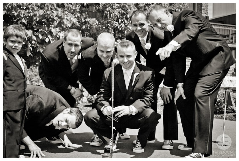 groomsmen help groom line up a put