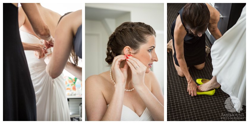 bride puts on pearl earrings, bridesmaid laces up wedding gown