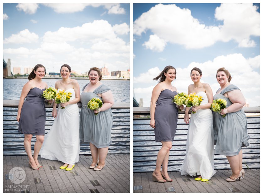 bridesmaids in grey dresses with yellow bouquets by the Delaware River