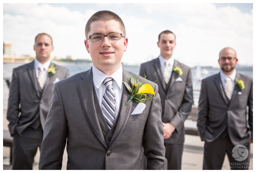groom in gray suit with yellow boutonniere