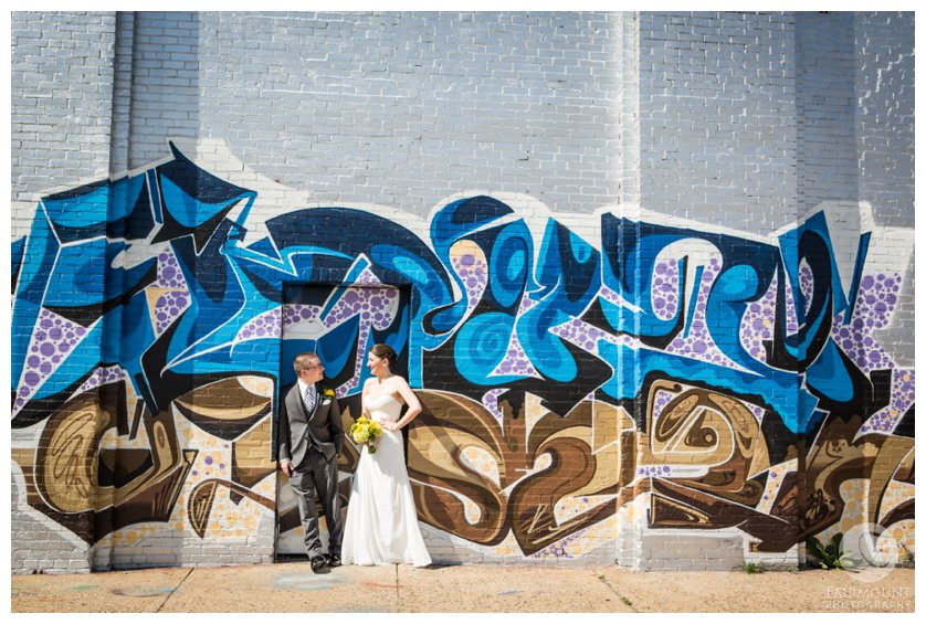 Bride & groom near grafitti wall in North Philadelphia
