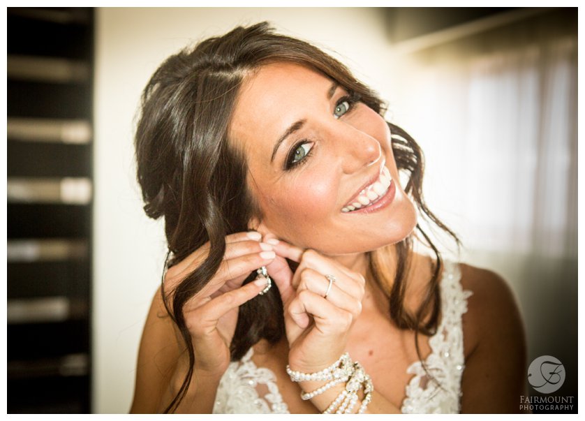 bride puts on earrings for Philadelphia wedding