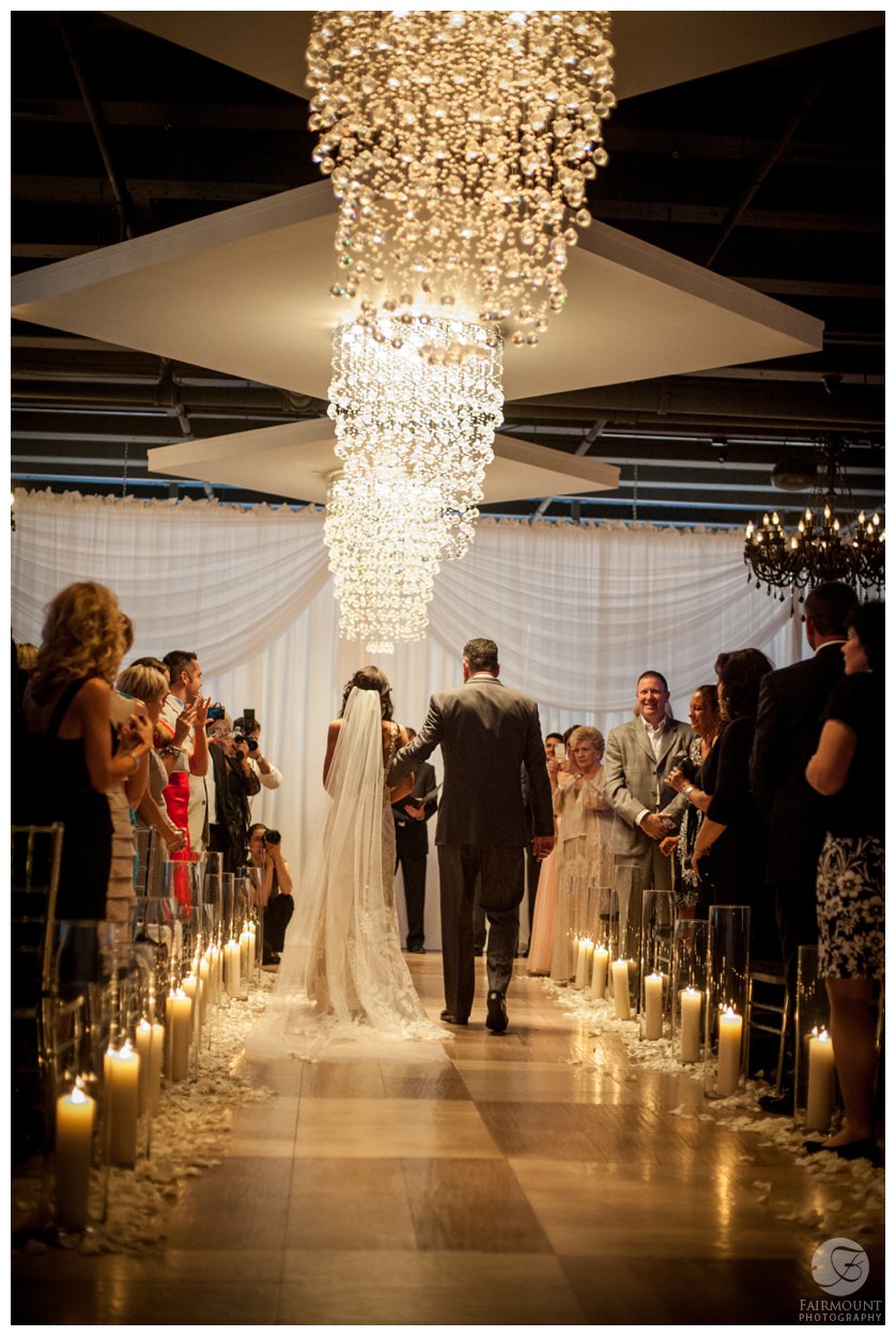 wedding ceremony at Tendenza with crystal chandeliers above the aisle