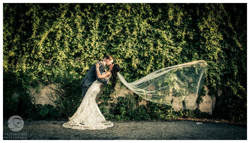 dramatic bridal portrait with long veil blowing in the wind