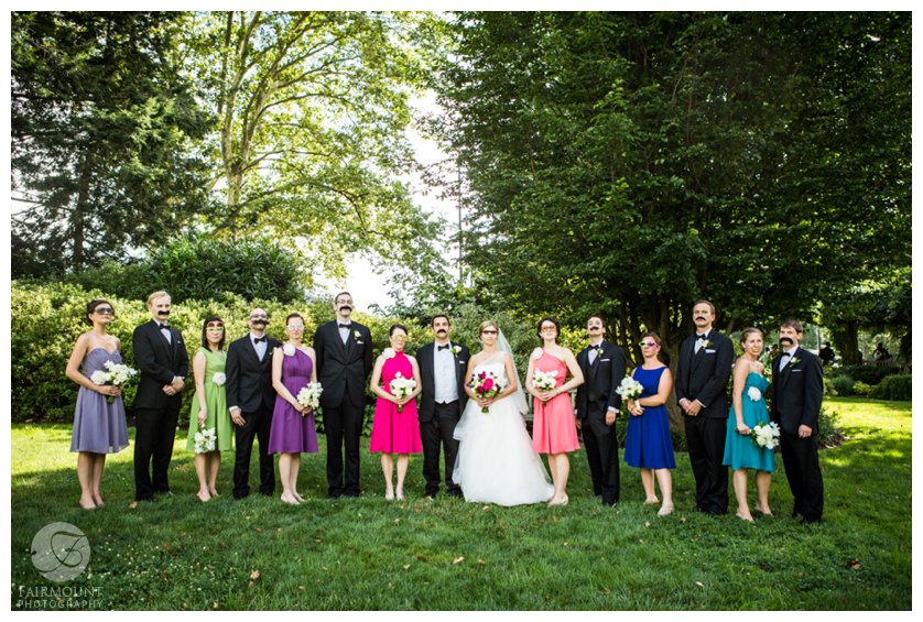 Bridal party wearing fake mustaches and goofy glasses