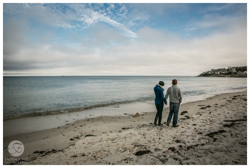 Couple walks along beach during Boston engagement photos