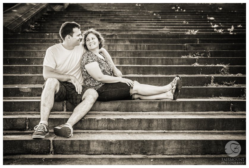 Couple smiles at each other on the steps behind the Philadelphia Museum of Art