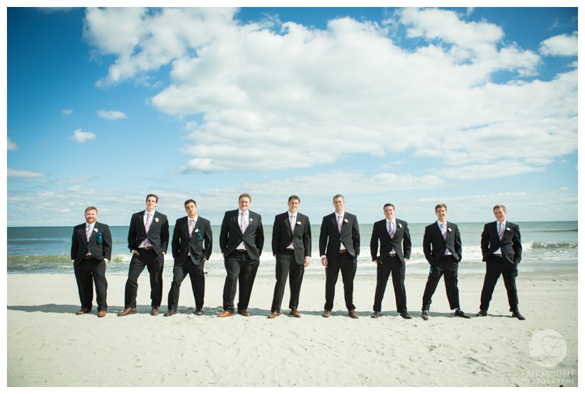groomsmen in front of the ocean at beach wedding