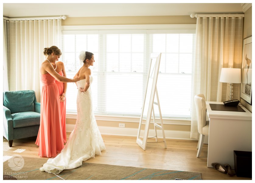 bride puts on wedding dress at The Reeds at Shelter Haven, a luxury boutique hotel