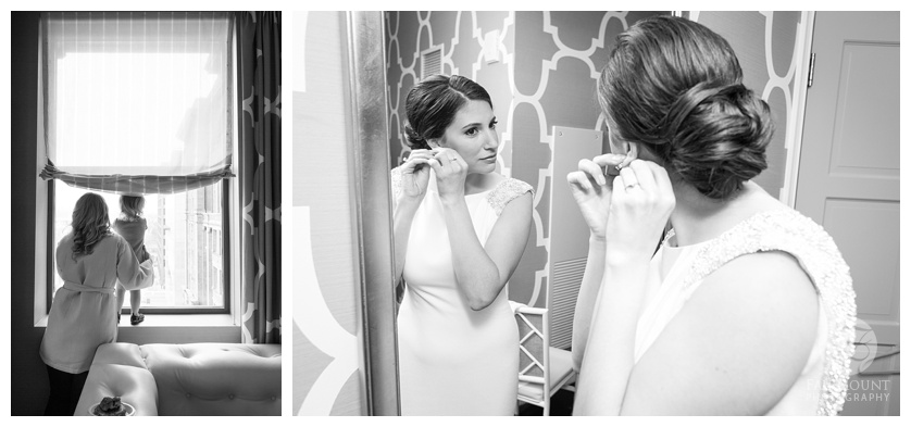 Bride looking in mirror. Bride putting earrings on in mirror.