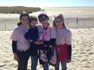 Dina Viskoc, a survivor walking at Jones Beach on Saturday, posed with her family, donning pink mustaches for breast cancer awareness. Photo by Briana Smith.