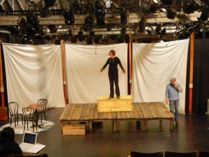 Set is now in progress, but not finished. Actors Mark Bramhall & Paige Lindsey White test out the spacing.