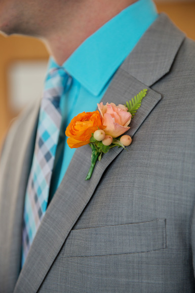 groom boutonniere in peach and orange