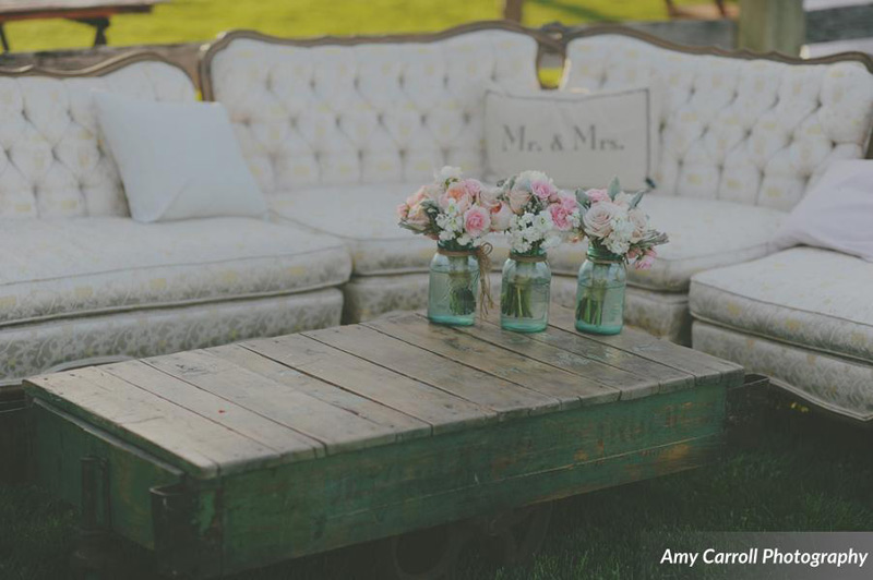 vintage sofa and coffee table at farm wedding