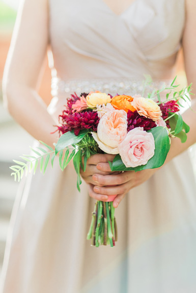 bridesmaids bouquet in peach, blush, burgundy and orange