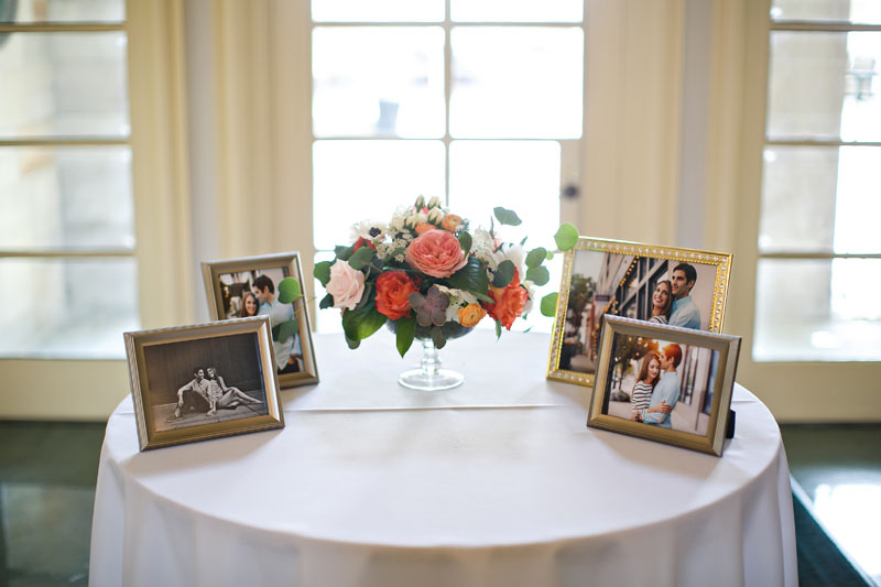 wedding entry welcome table with photos and flowers
