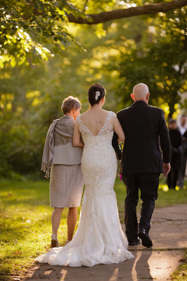 bride and parents walking down the aisle