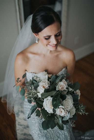 winter wedding bride with green and white bouquet