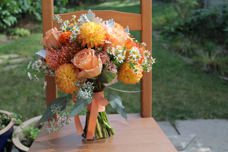 orange autumn wedding bride's bouquet with contemporary chevron ribbon