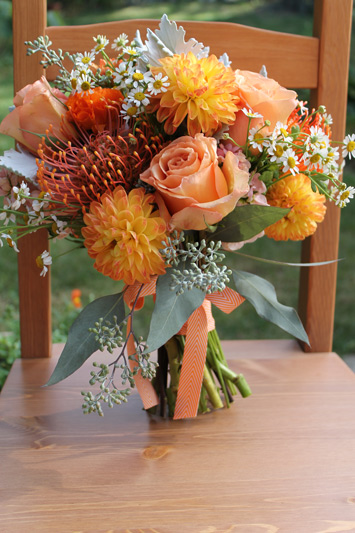 orange bride bouquet with chevron ribbon