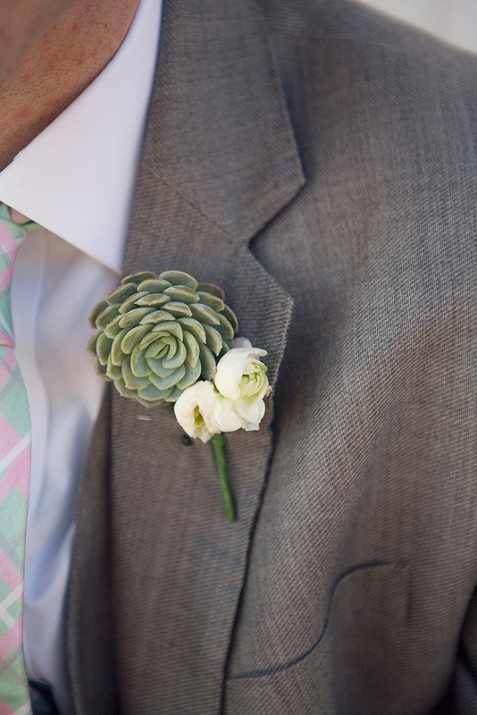 groom boutonniere of white ranunculus and succulent