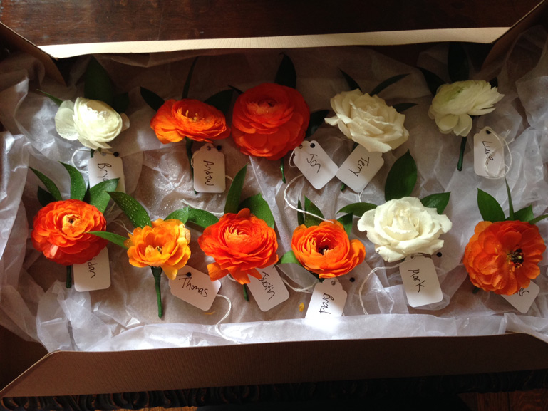 orange and white wedding boutonnieres by red poppy floral design ann arbor michigan
