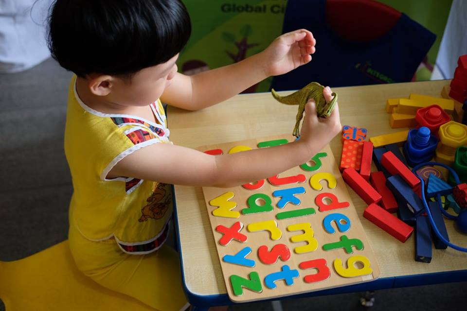 A child playing while learning the alphabet
