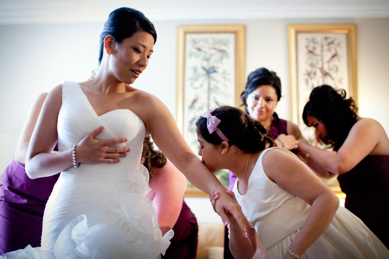 Bride getting ready in La Sposa wedding gown at Ritz Carlton in Half Moon Bay, California.