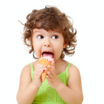 little curly girl with ice cream in studio isolated