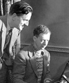 Benjamin Britten, at the piano, studying a score along side his partner and tenor, Peter Pears.