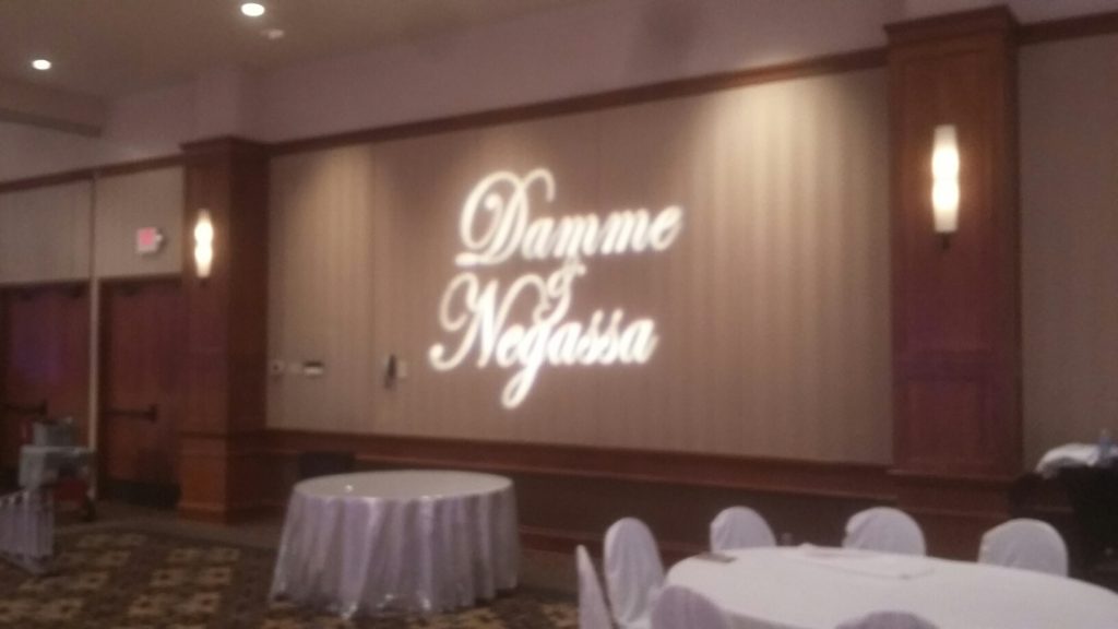 Picture of a Gobo lighting effect in which a wedding couple's name is displayed on a wall