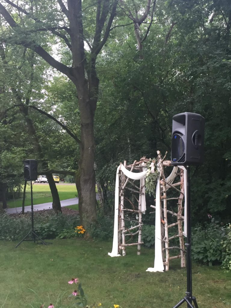 Picture of outdoor wedding archway and AV for You speakers