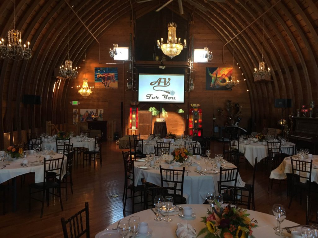 Picture of the interior of the Green Acres Event Center with AV equipment set up.