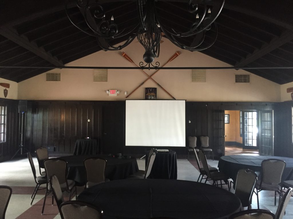 Picture of AV for You audio and video for an event at the Minnesota Boat club. The equipment included one K10 speaker, a handeld wirless microphone, and a projector.