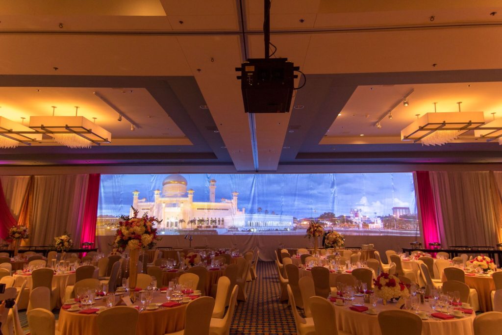 Picture of AV for AV for You Wedding AV rental Minneapolis Marriott City Center rental. Picture shows three 12,000 lumen projectors with an image that is blended in one 56’x11’ image.