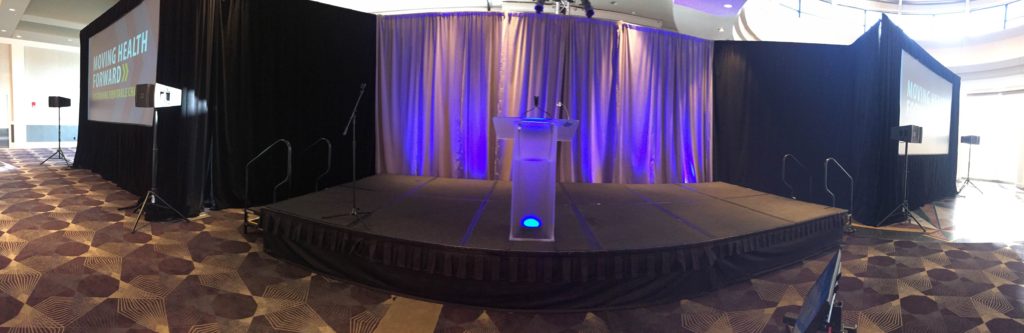 Picture of AV for You Rental Blue Cross Blue Shield Minnesota Luncheon at Intercontinental Hotel set-up featuring staging and a frosted podium with uplights