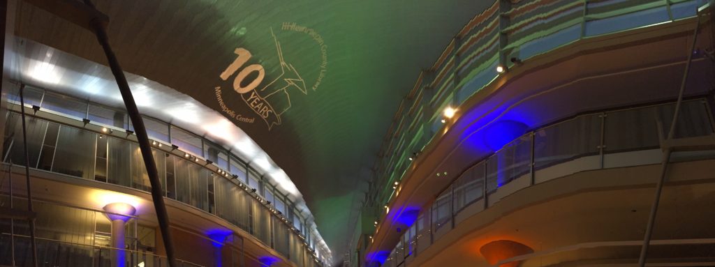 AV for You was thrilled to provide audio, video, and lighting to celebrate the 10th Anniversary Celebration of the Minneapolis Central Library in Downtown Minneapolis, MN. This picture shows the Minneapolis Central Library Logo using our a source 4 light to project a custom made gobo on the ceiling.
